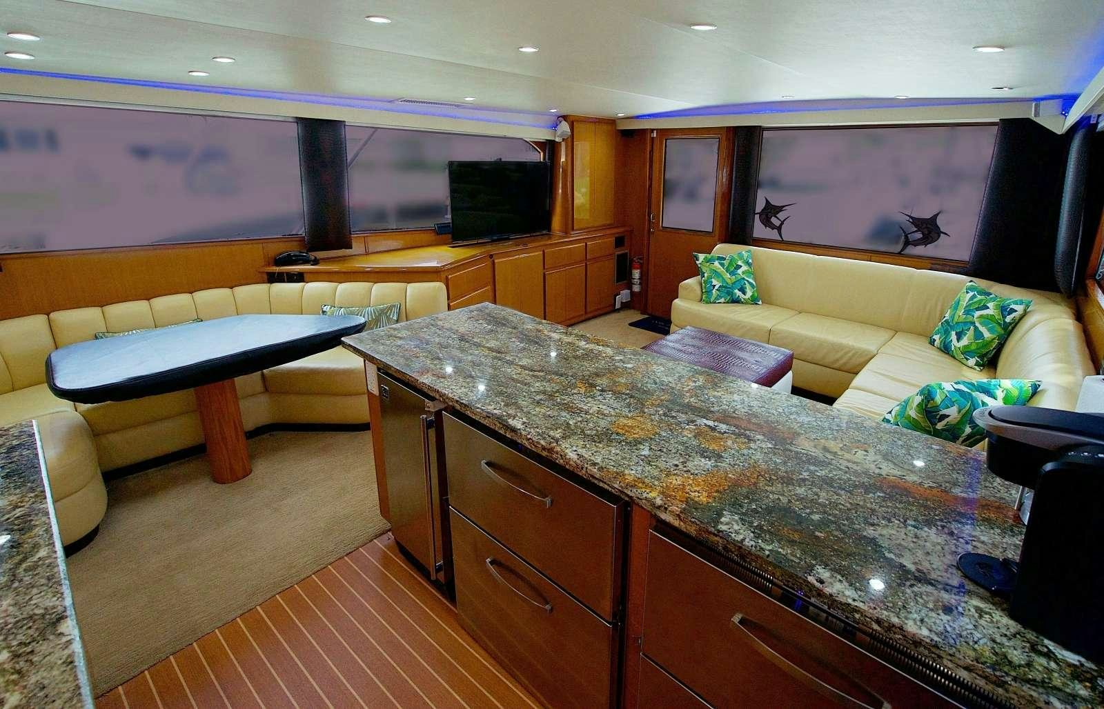 a large living room with a kitchen and a bar aboard MISS KETHLEEN Yacht for Charter