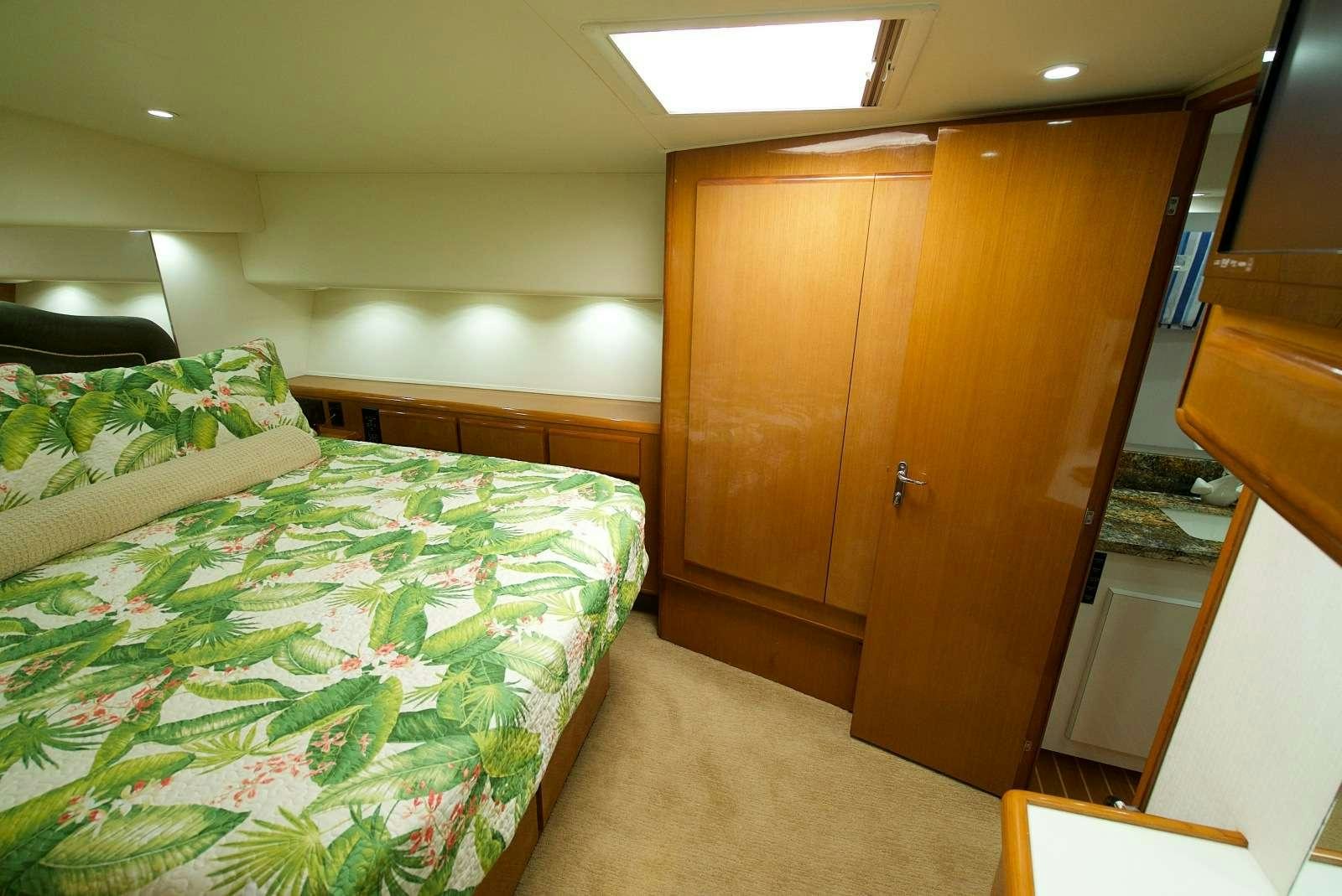 a bedroom with a bed and a closet aboard MISS KETHLEEN Yacht for Charter