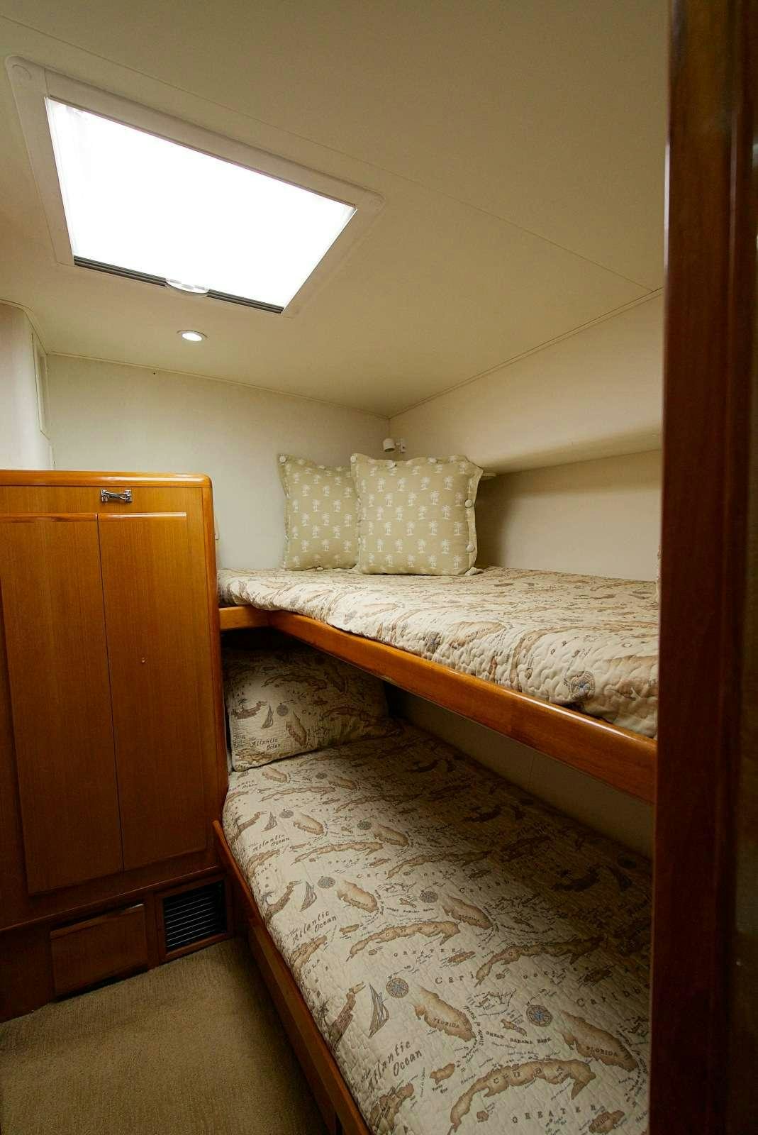 a bed with a white comforter aboard MISS KETHLEEN Yacht for Charter