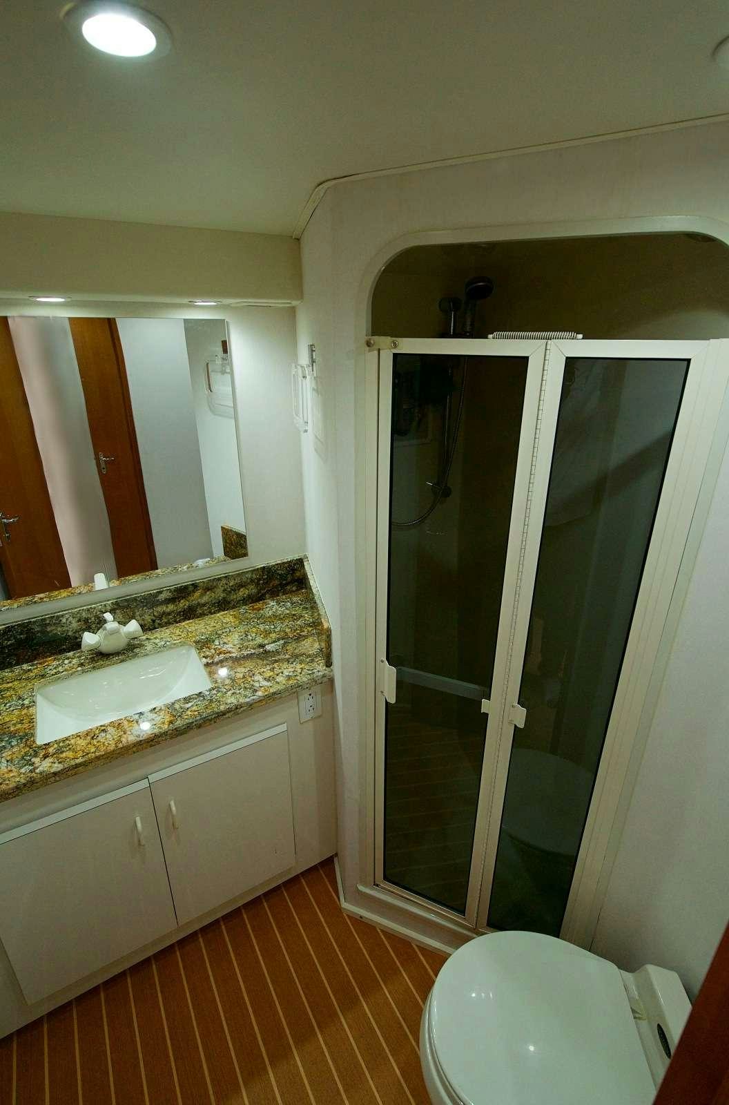 a bathroom with a glass shower aboard MISS KETHLEEN Yacht for Charter