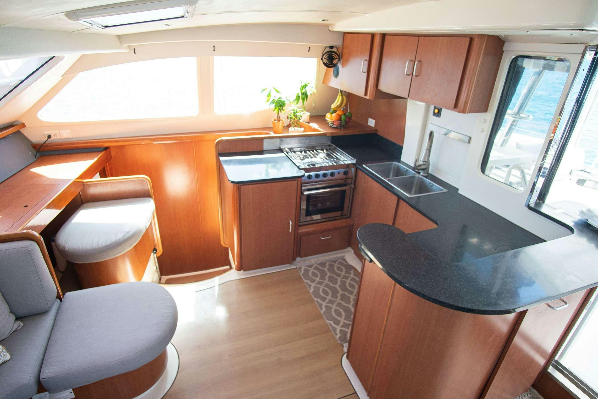 a kitchen with a stove and cabinets aboard ISLAND R&amp;R Yacht for Charter