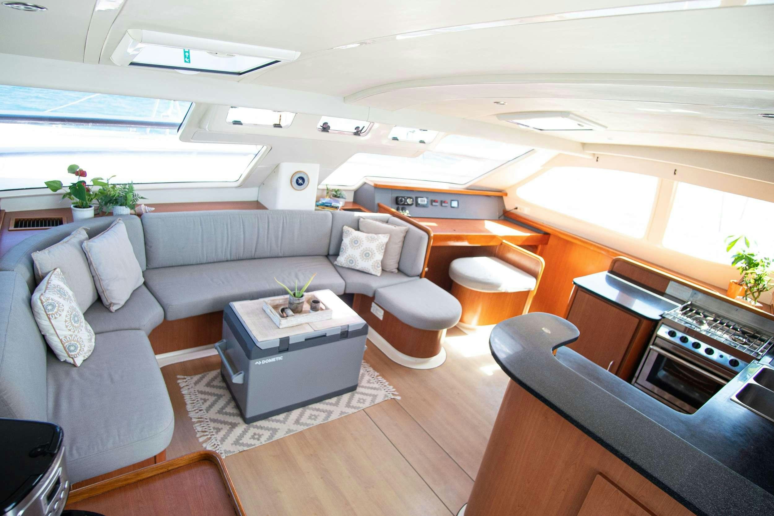 a living room with a couch and a coffee table aboard ISLAND R&amp;R Yacht for Charter