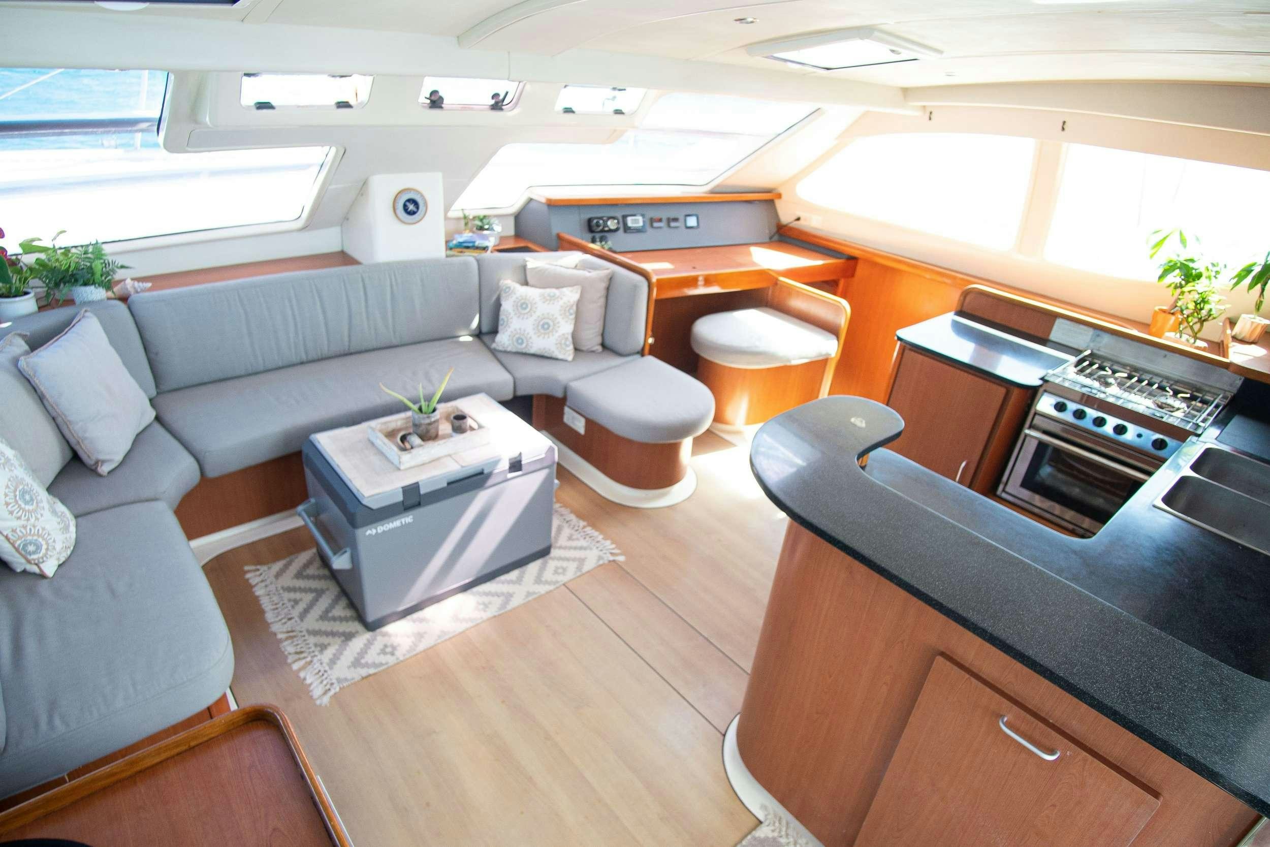 a living room with a couch and a piano aboard ISLAND R&amp;R Yacht for Charter
