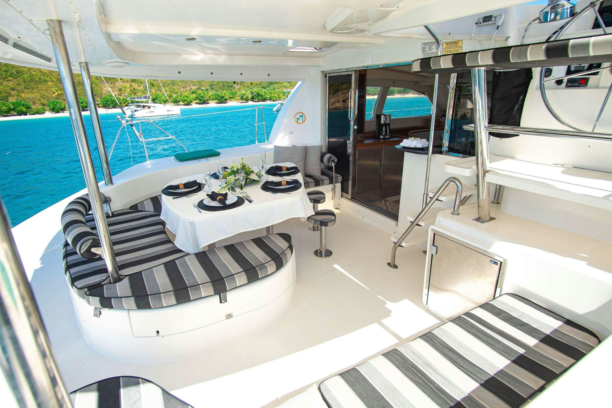a room with a pool table and chairs aboard ISLAND R&amp;R Yacht for Charter