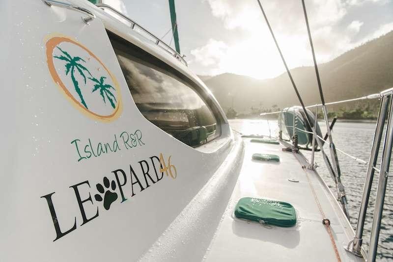 a white vehicle with a green tag aboard ISLAND R&amp;R Yacht for Charter