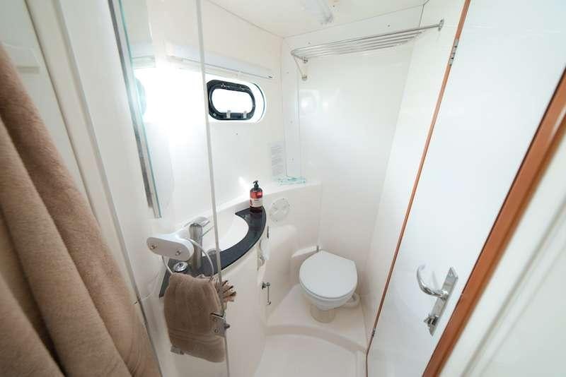 a bathroom with a toilet and a shower aboard ISLAND R&amp;R Yacht for Charter