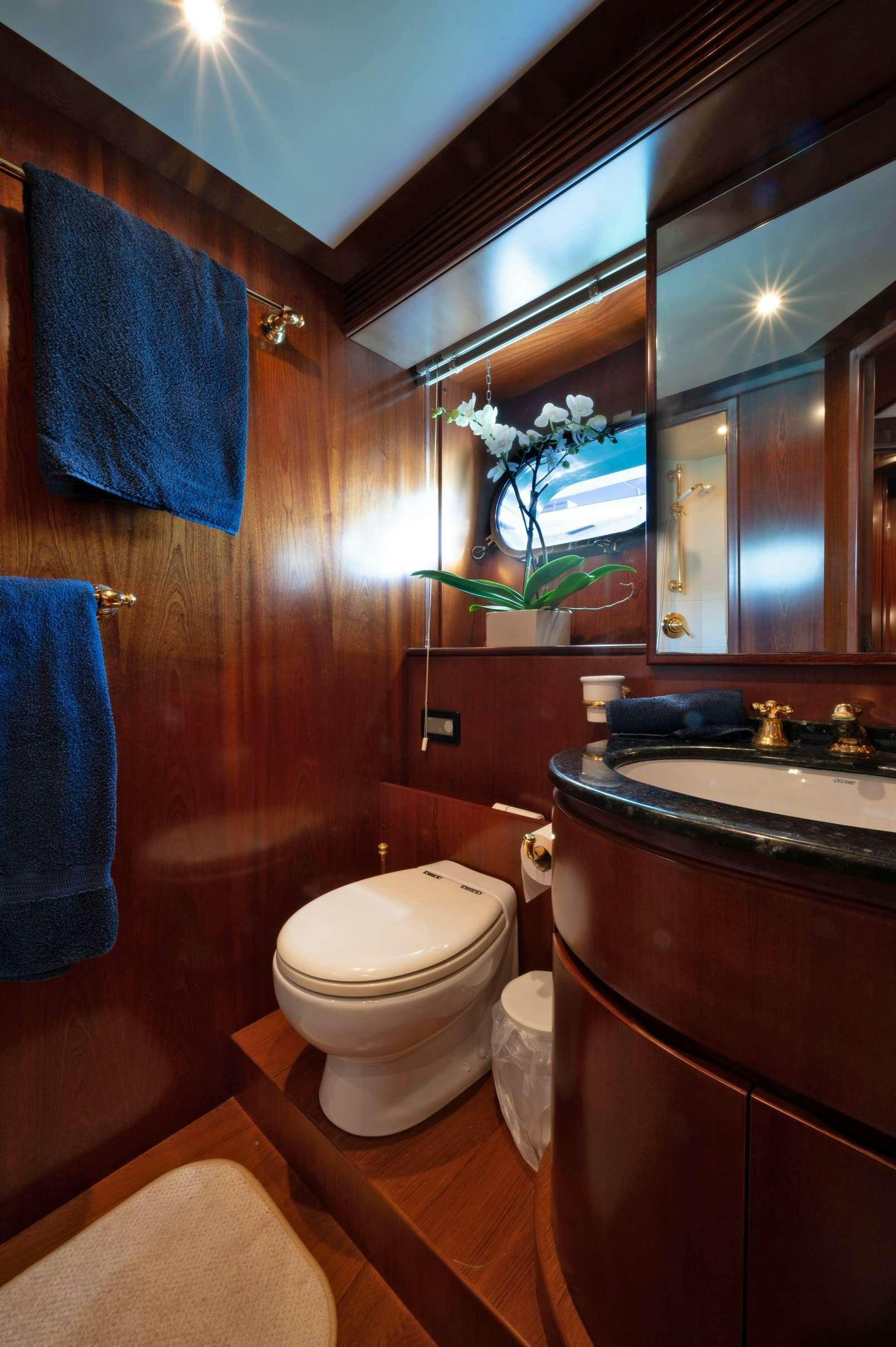 a bathroom with a toilet and a sink aboard FIRST LADY II Yacht for Charter