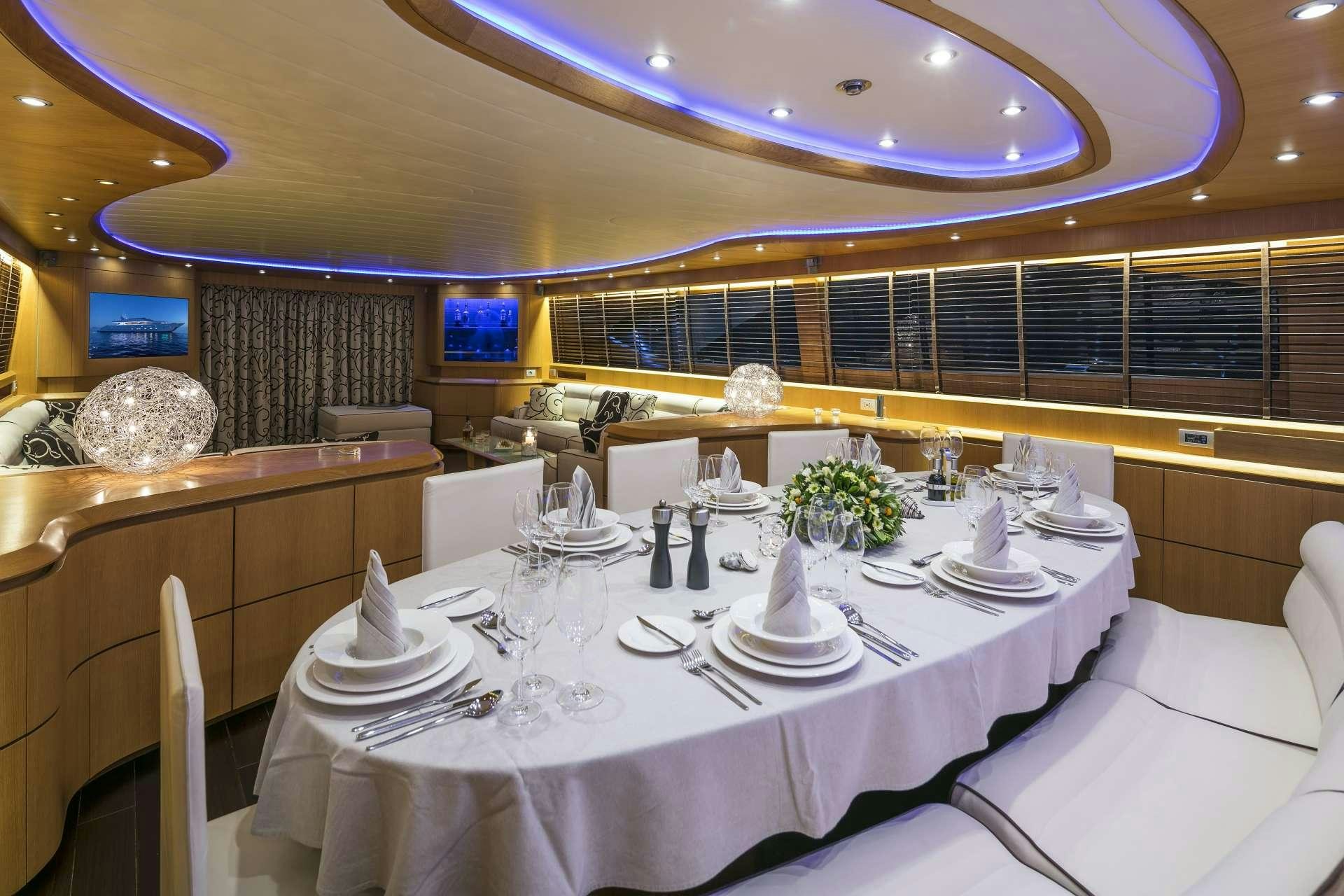 a table set with plates and glasses aboard ANASA Yacht for Charter