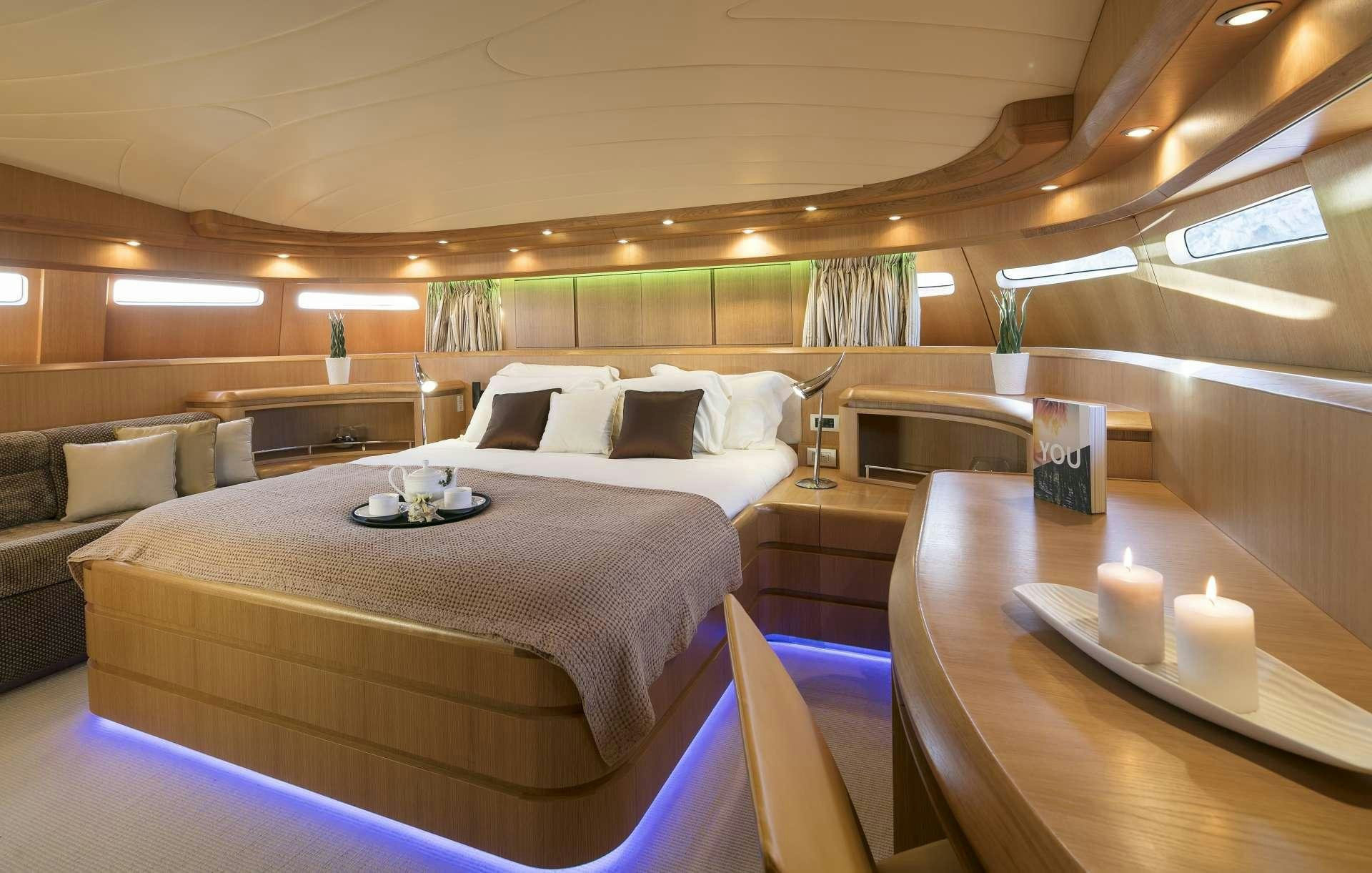 a room with a bed and a couch aboard ANASA Yacht for Charter