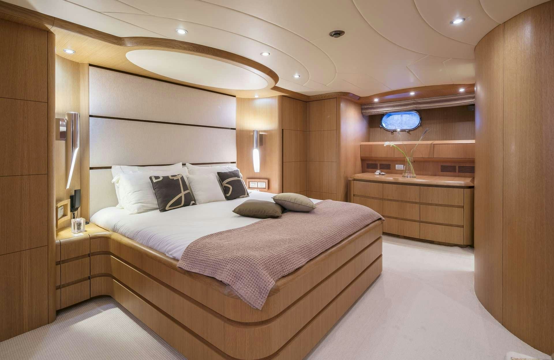 a room with a bed and a desk aboard ANASA Yacht for Charter