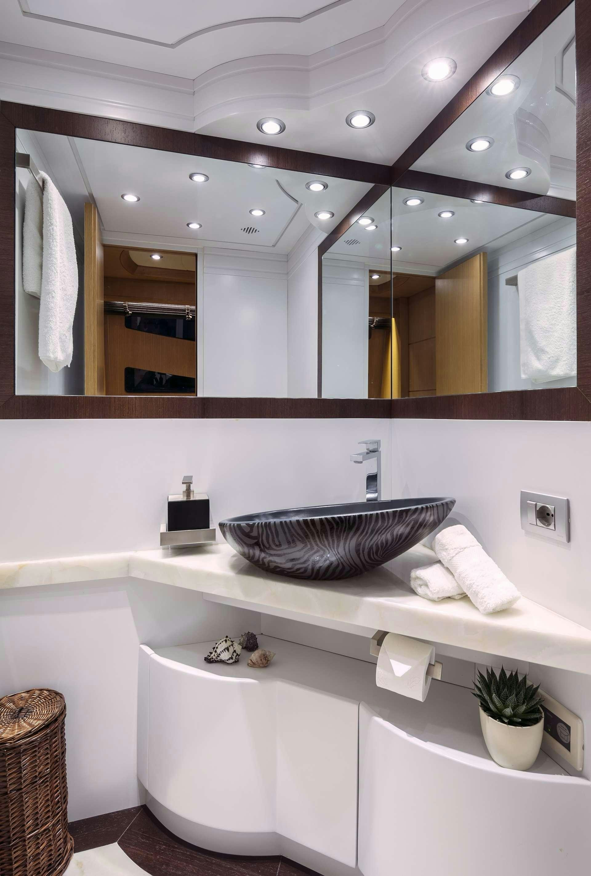 a bathroom with a large mirror aboard ANASA Yacht for Charter