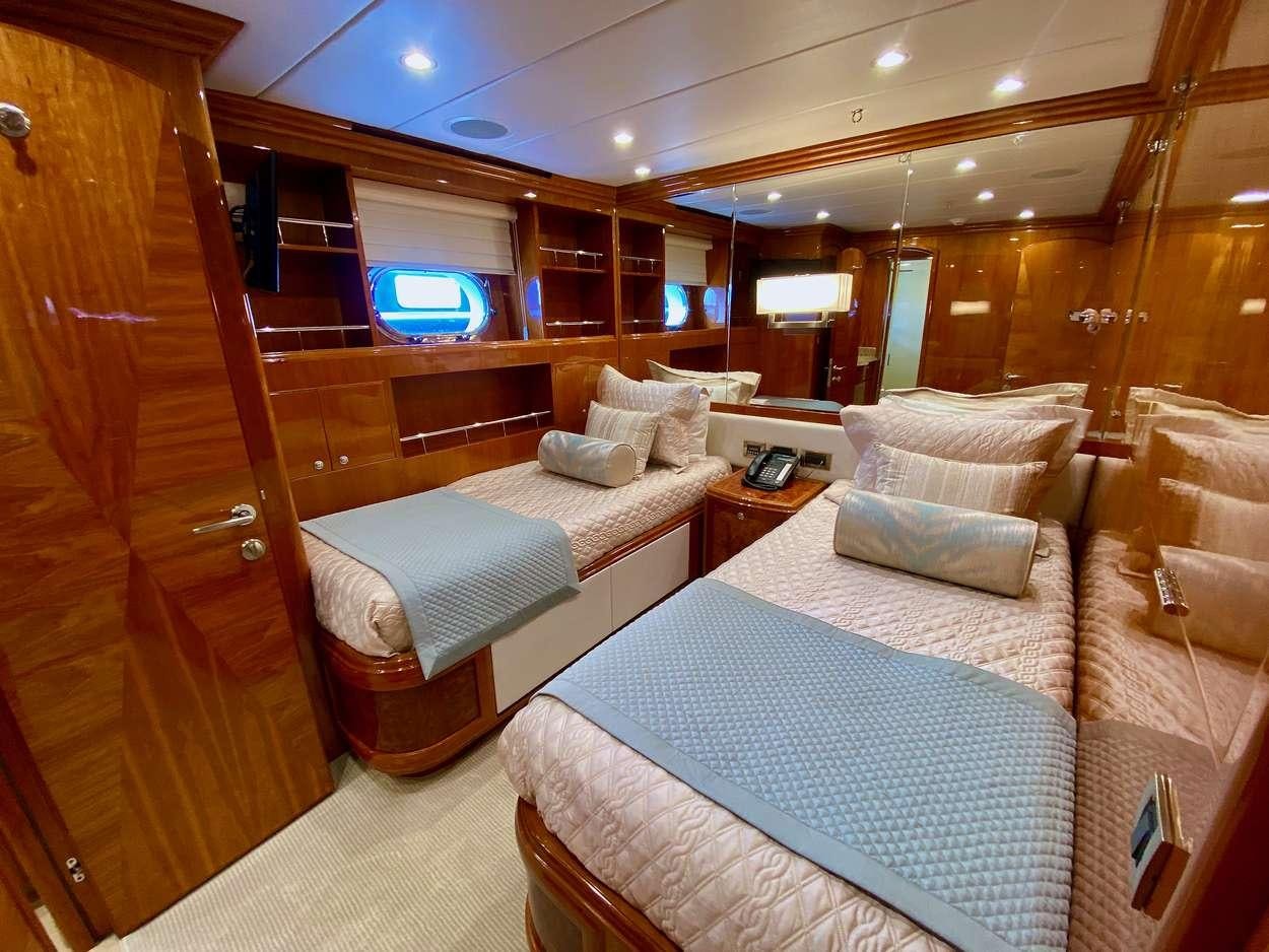a room with a bed and a couch aboard BRANDI WINE Yacht for Charter