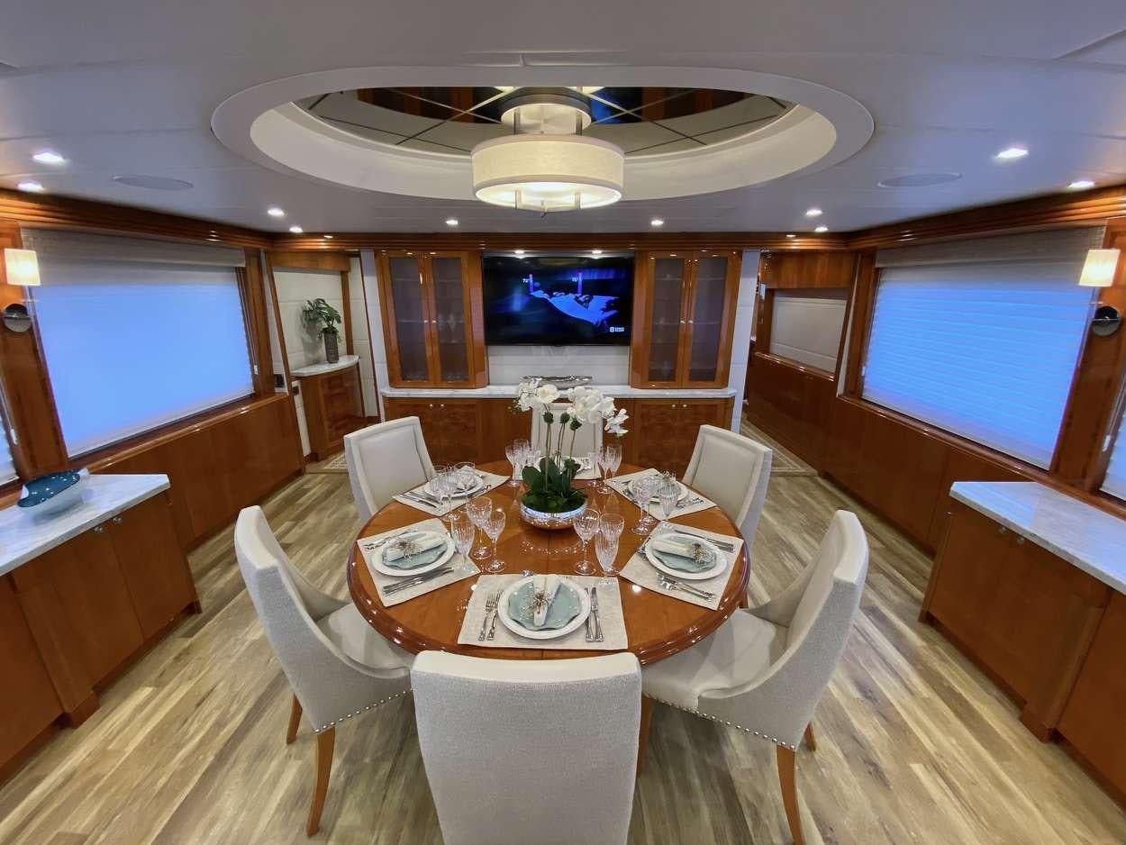 a dining room with a table and chairs aboard BRANDI WINE Yacht for Charter