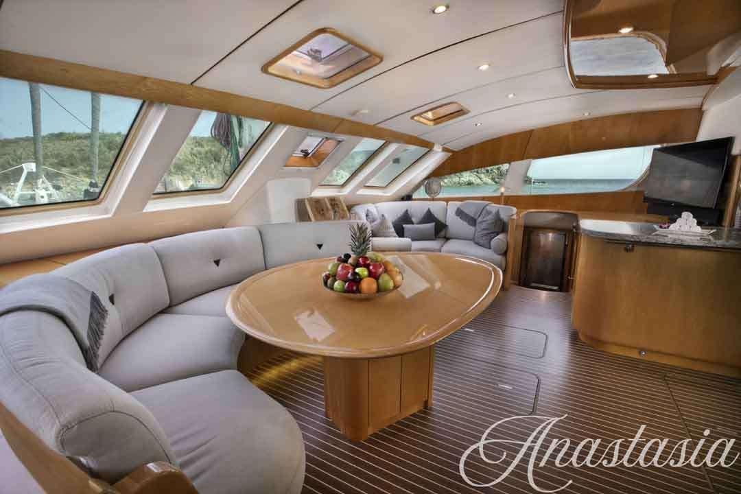 a living room with a table and couches aboard ANASTASIA Yacht for Charter