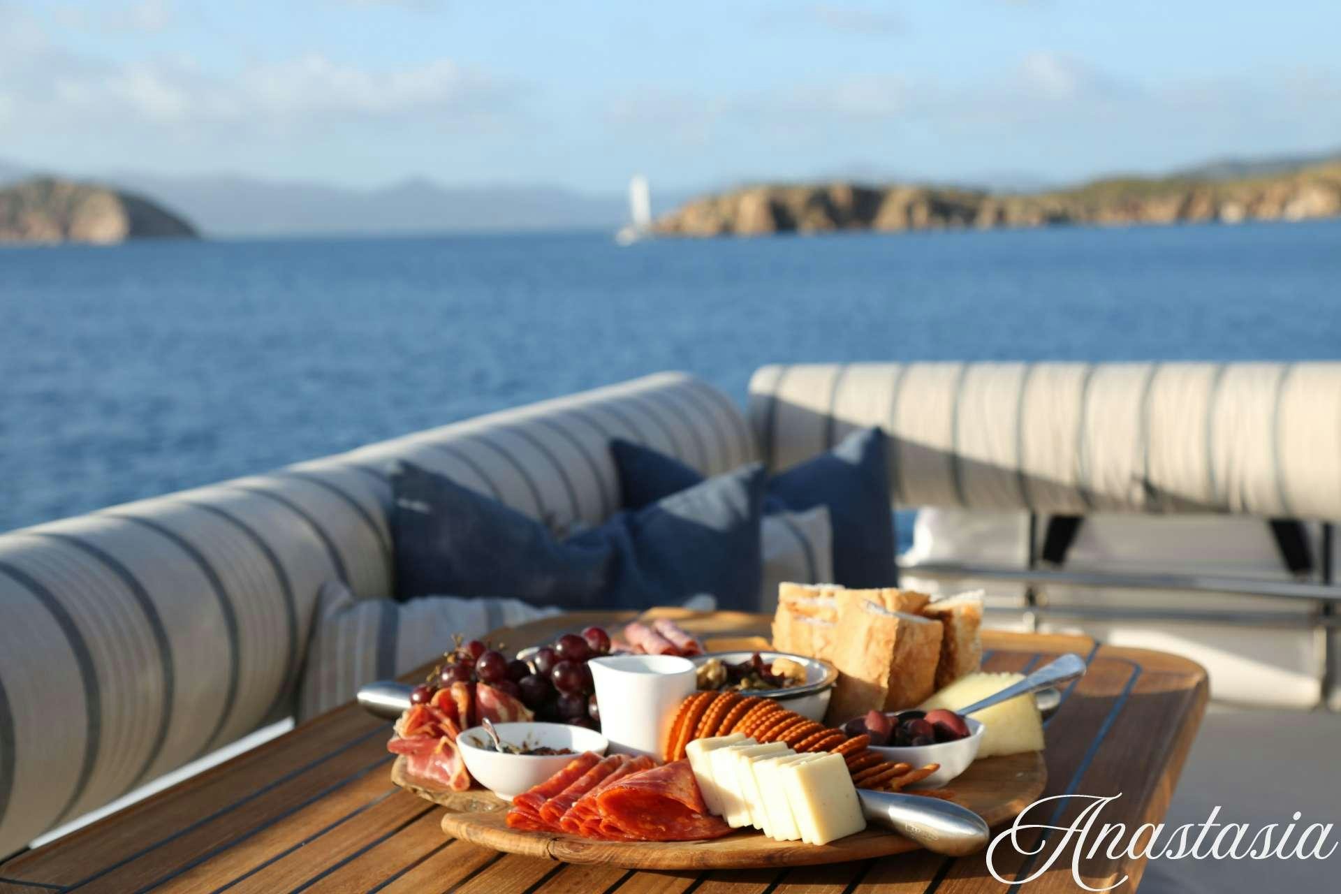 a table with food on it by the water aboard SWEET ANN MARIE Yacht for Charter