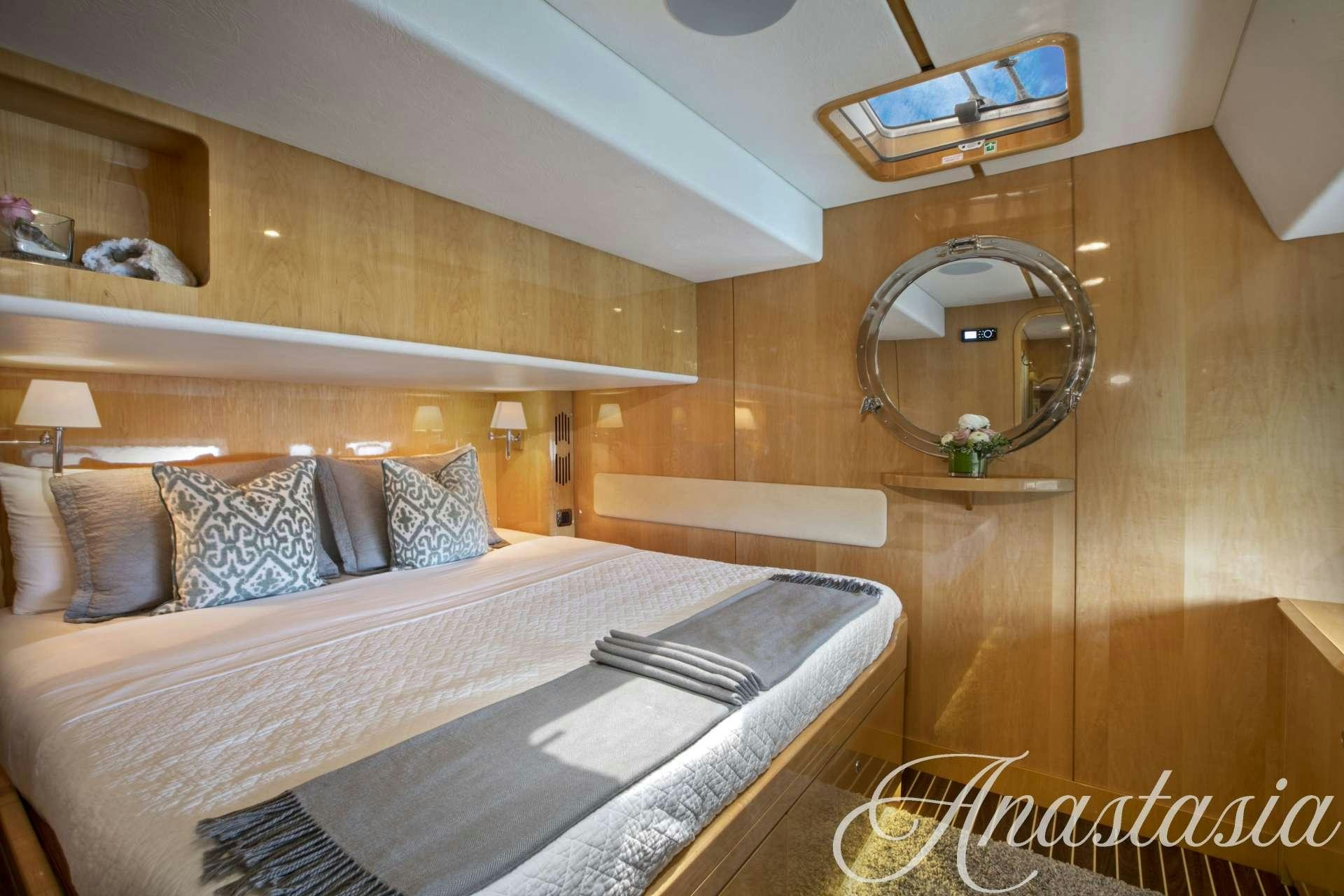 a bed with a mirror above it aboard ANASTASIA Yacht for Charter