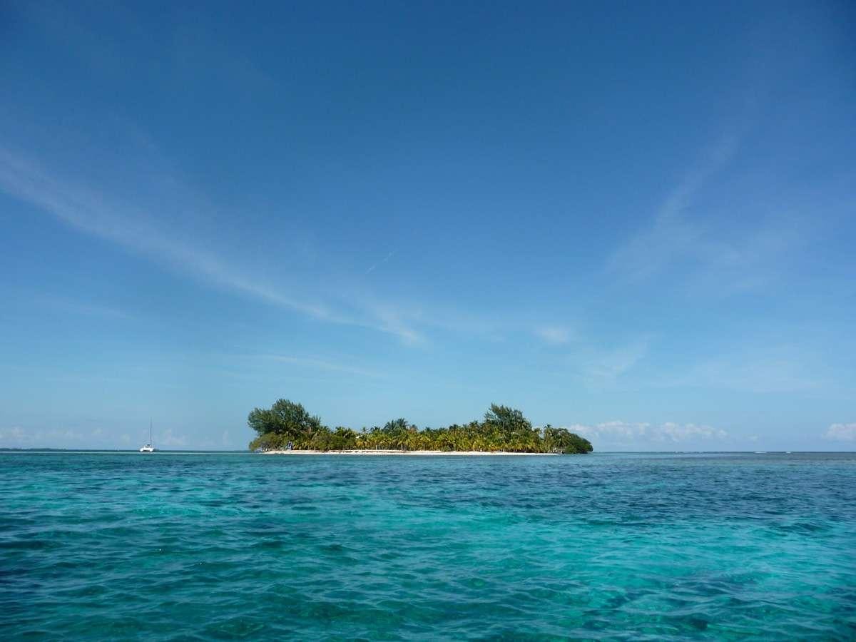a small island with a small island in the middle of the ocean aboard DORIS Yacht for Charter
