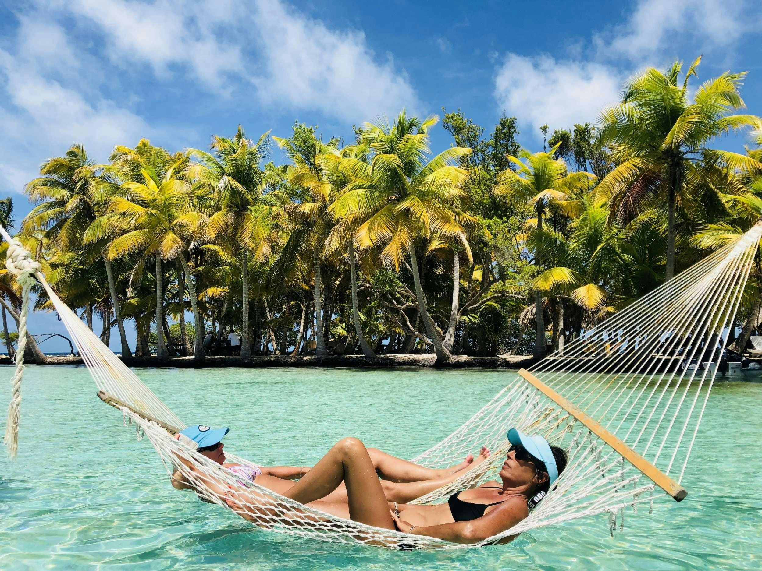a person lying on a hammock in a hammock aboard DORIS Yacht for Charter