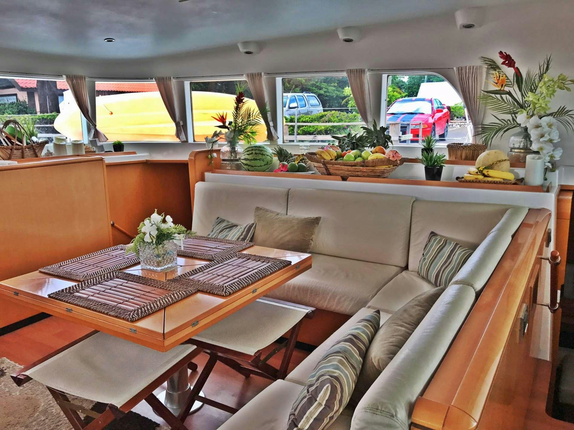 a living room with a table and couches aboard DORIS Yacht for Charter