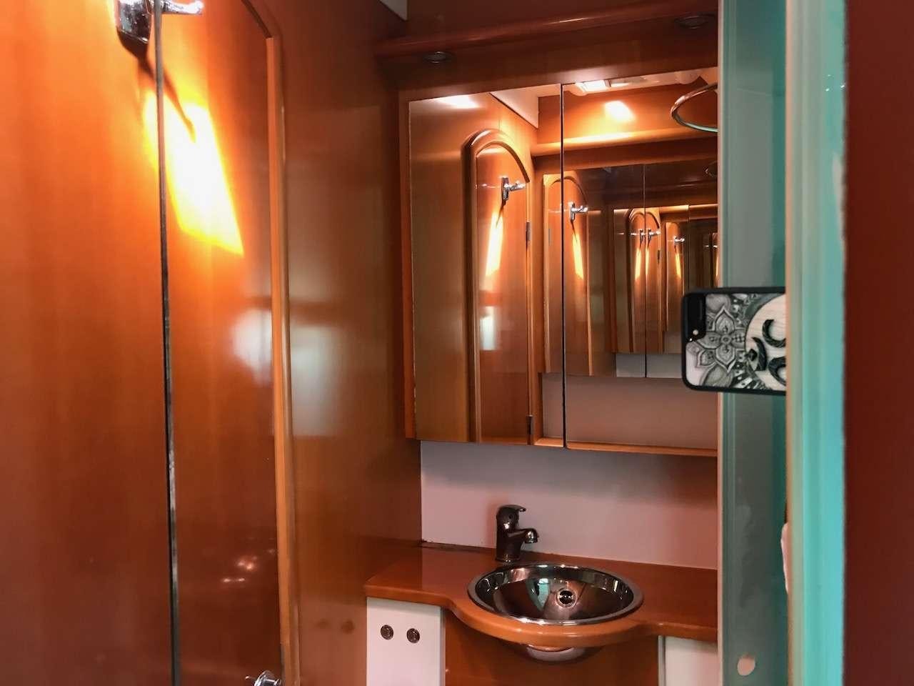 a bathroom with a sink and a mirror aboard DORIS Yacht for Charter