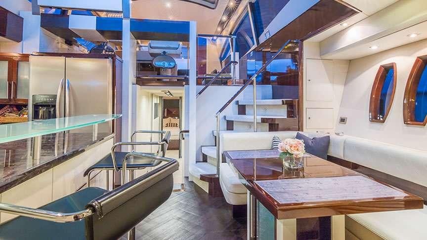 a room with a table and chairs aboard LADY H Yacht for Charter