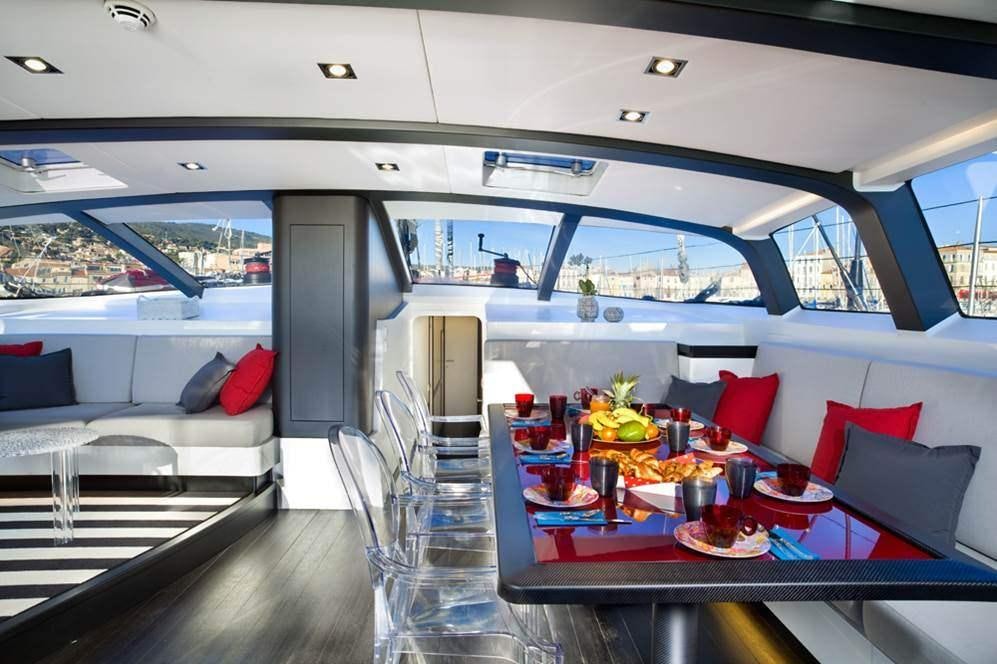 a room with a table and chairs aboard NOMAD IV Yacht for Charter