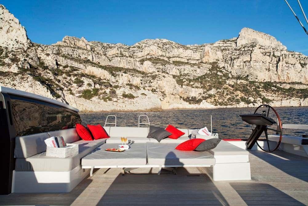 a boat with a red and white boat on it aboard NOMAD IV Yacht for Charter