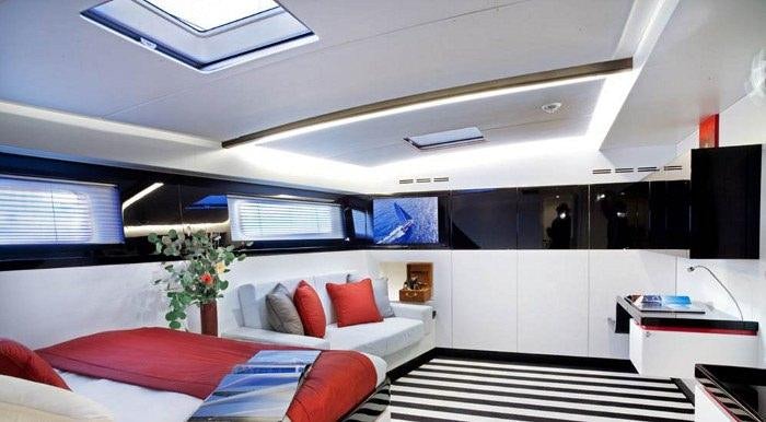 a room with a couch and a television aboard NOMAD IV Yacht for Charter
