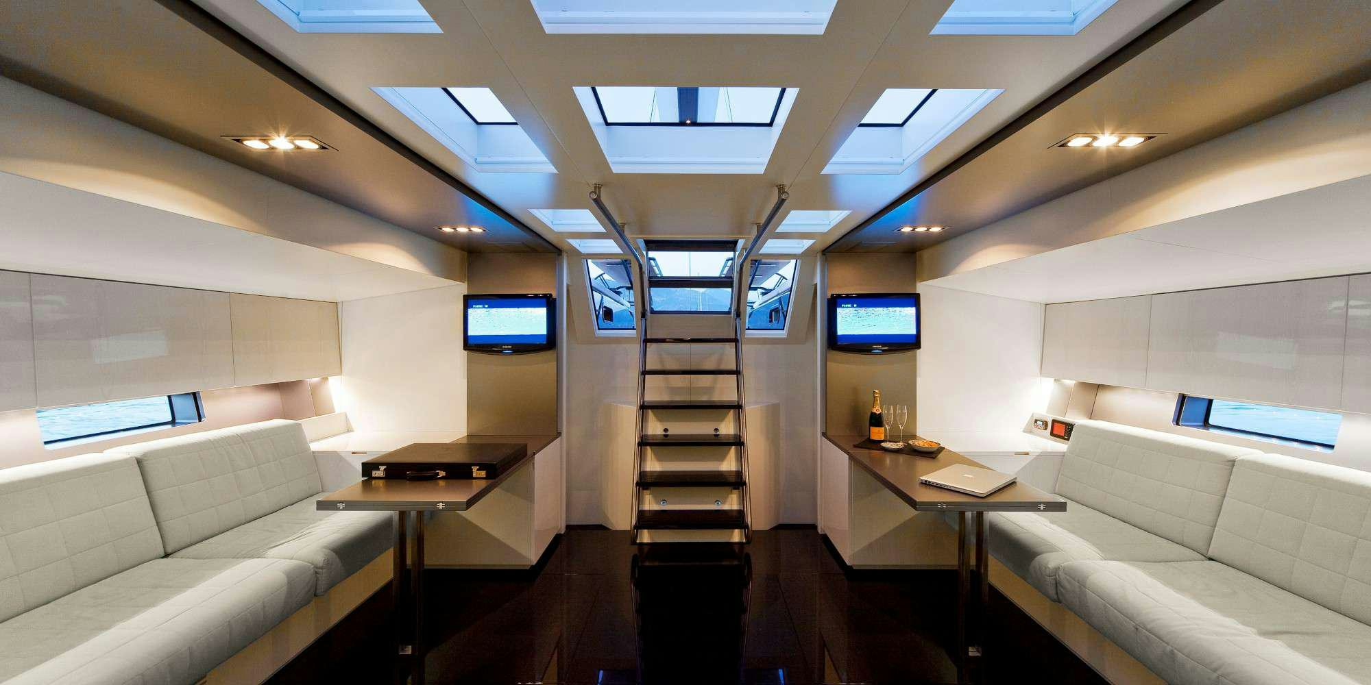 a room with a couch and a television aboard AESOP Yacht for Charter