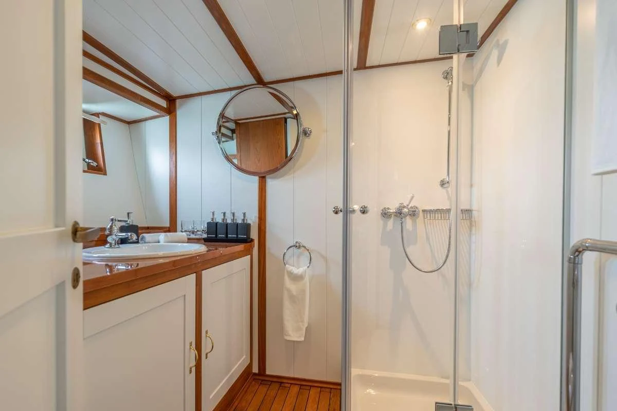a bathroom with a shower unit aboard CAMARA C Yacht for Charter
