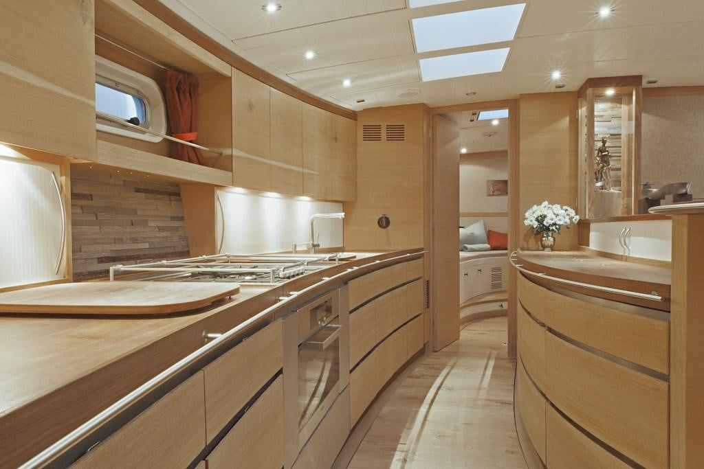 a kitchen with wooden cabinets aboard HELENE Yacht for Charter