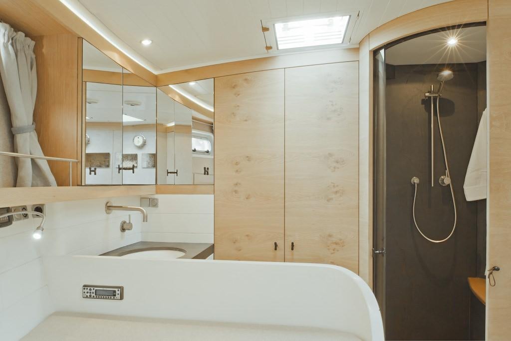 a bathroom with a sink and a shower aboard HELENE Yacht for Charter