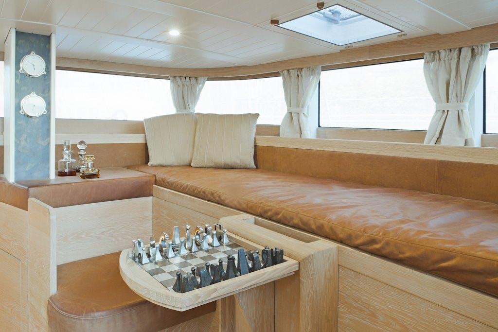 a bed with a tray of bottles aboard HELENE Yacht for Charter