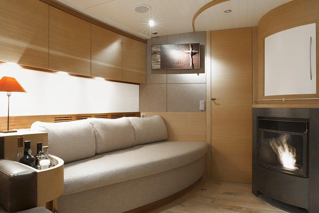 a living room with a fireplace aboard HELENE Yacht for Charter