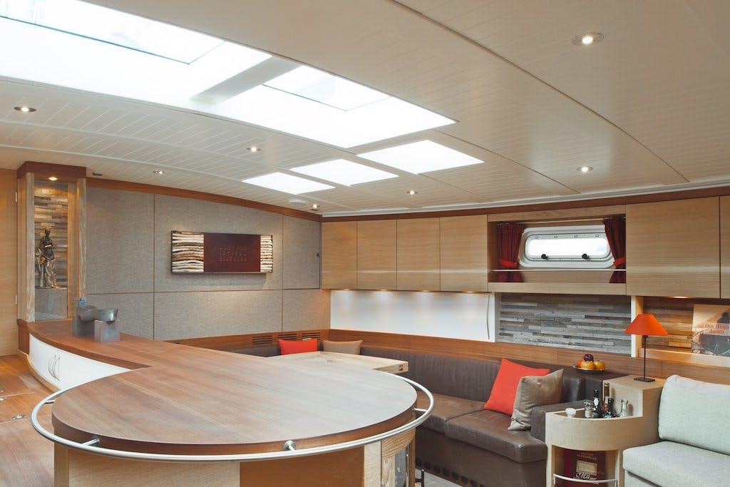 a room with a bed and a couch aboard HELENE Yacht for Charter