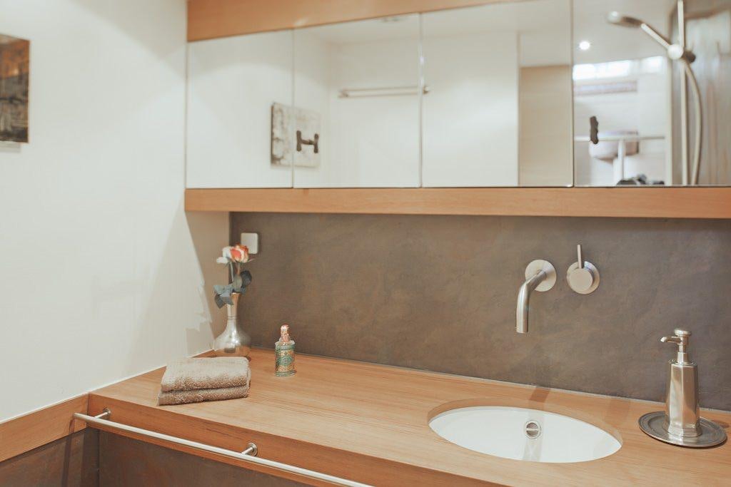 a bathroom with a large mirror aboard HELENE Yacht for Charter
