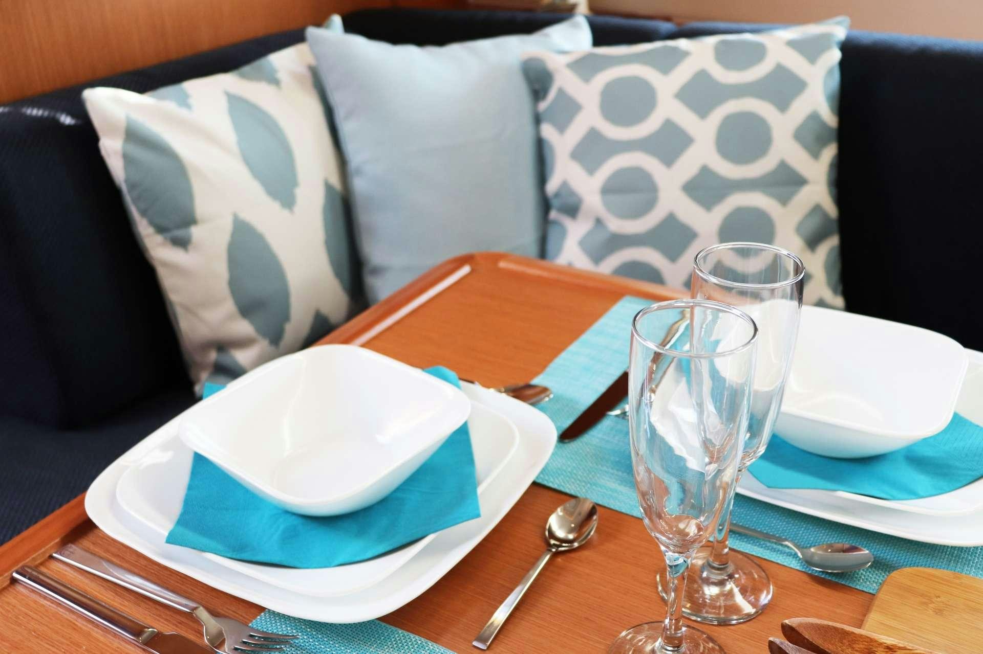 a table with empty plates and silverware on it aboard Wyvern Yacht for Charter