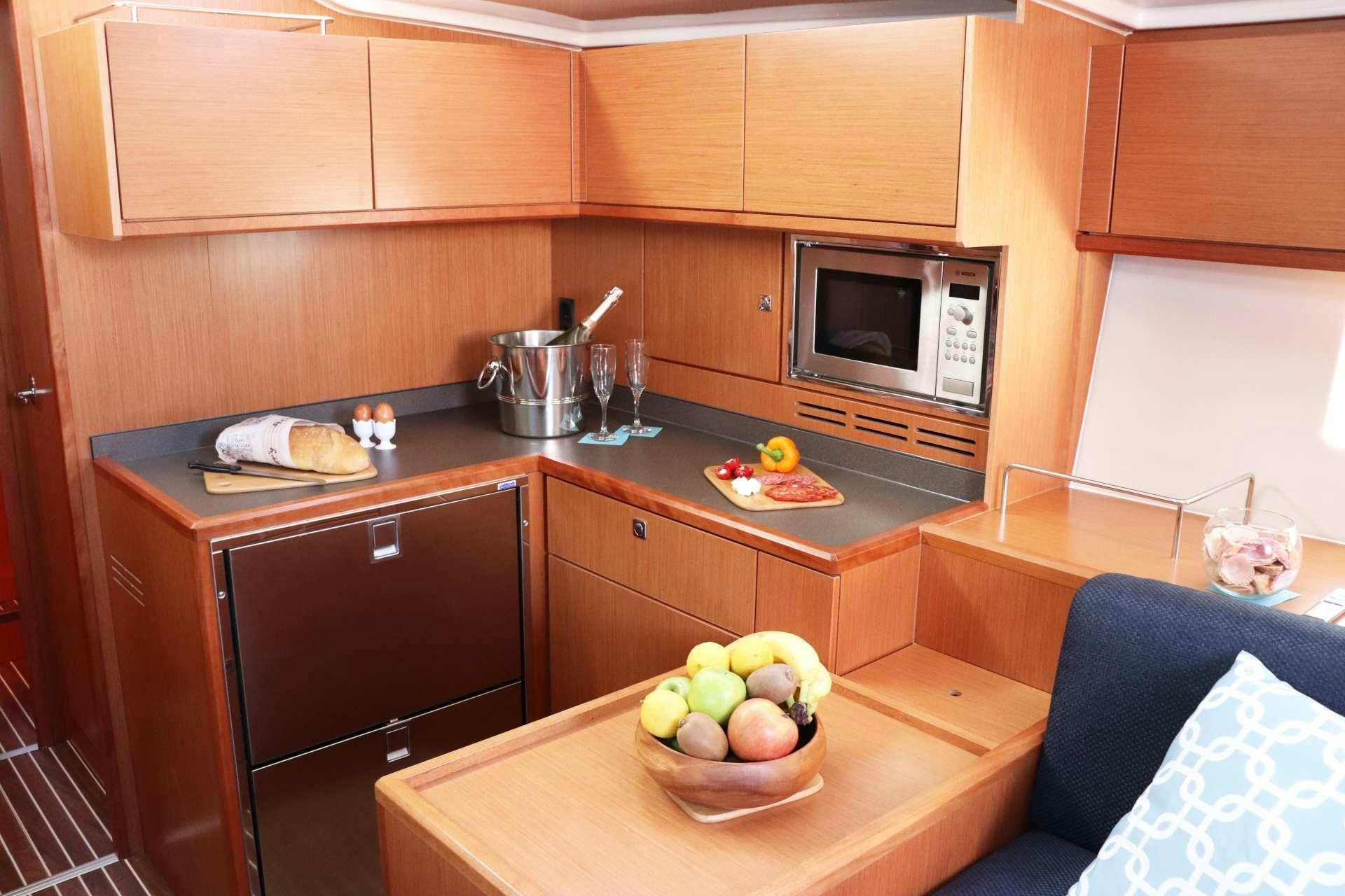 a kitchen with a bowl of fruit aboard Wyvern Yacht for Charter