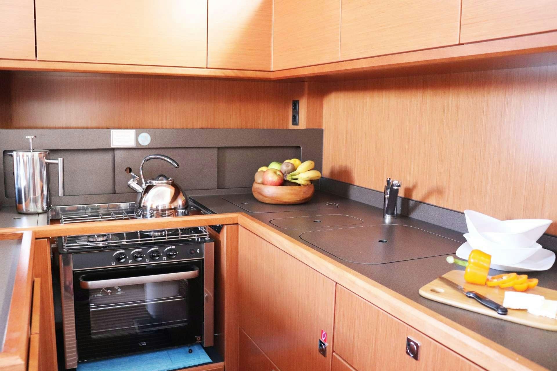 a kitchen with a pot of fruit on the stove aboard Wyvern Yacht for Charter