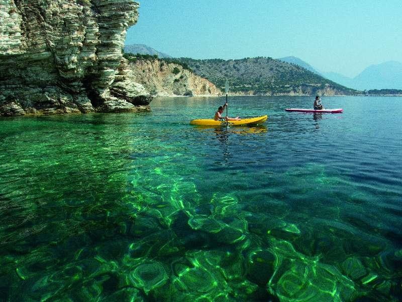 a couple of people in kayaks in a lake aboard Wyvern Yacht for Charter