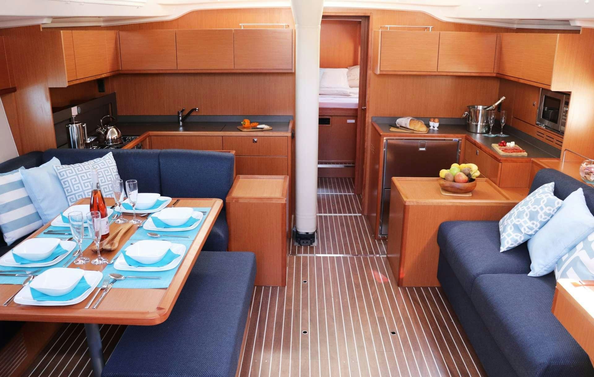 a kitchen with a table and chairs aboard Wyvern Yacht for Charter
