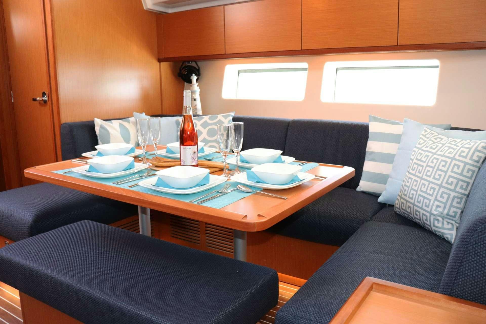 a table with plates and bottles on it aboard Wyvern Yacht for Charter