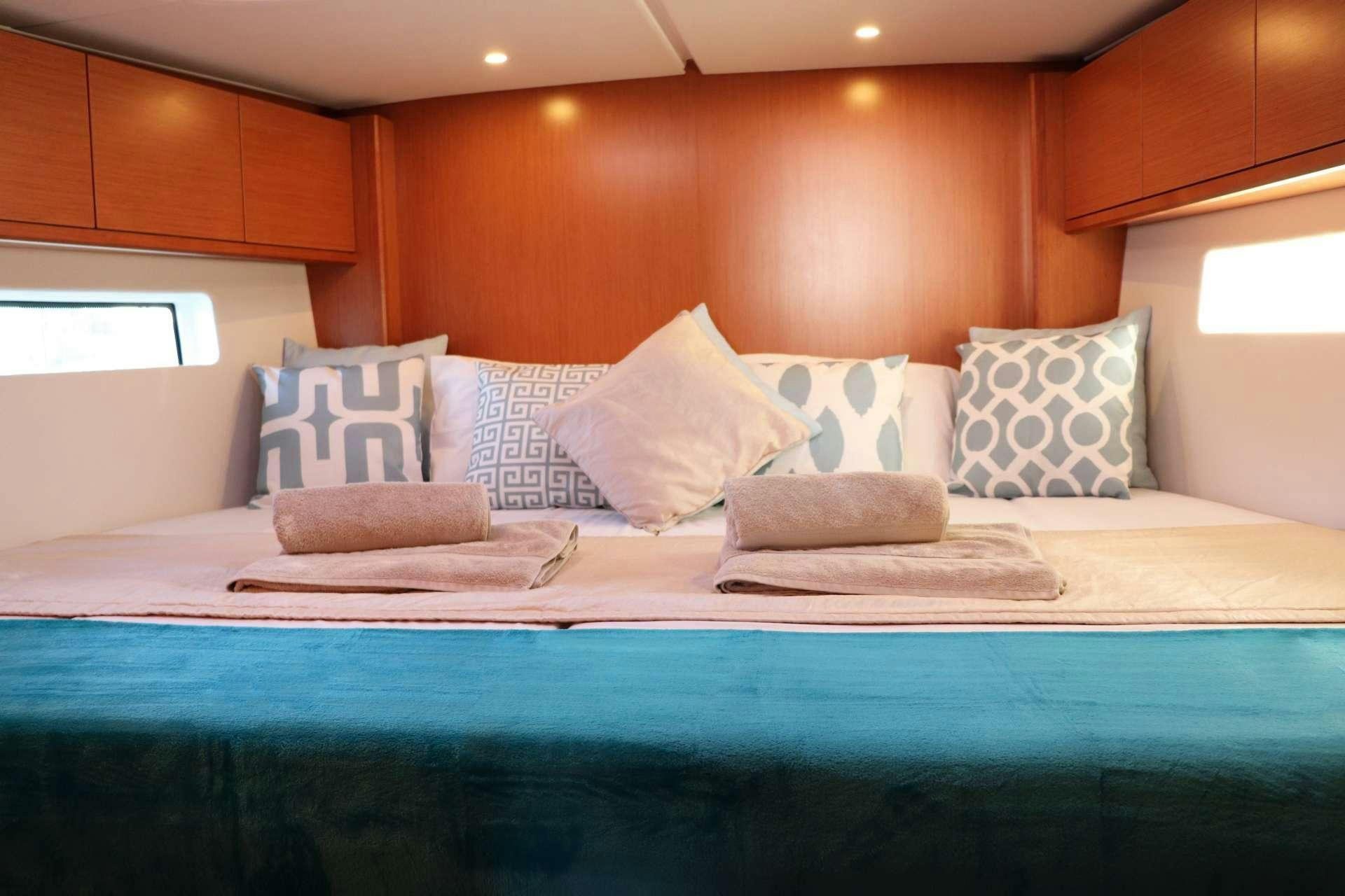 a bed with pillows aboard Wyvern Yacht for Charter
