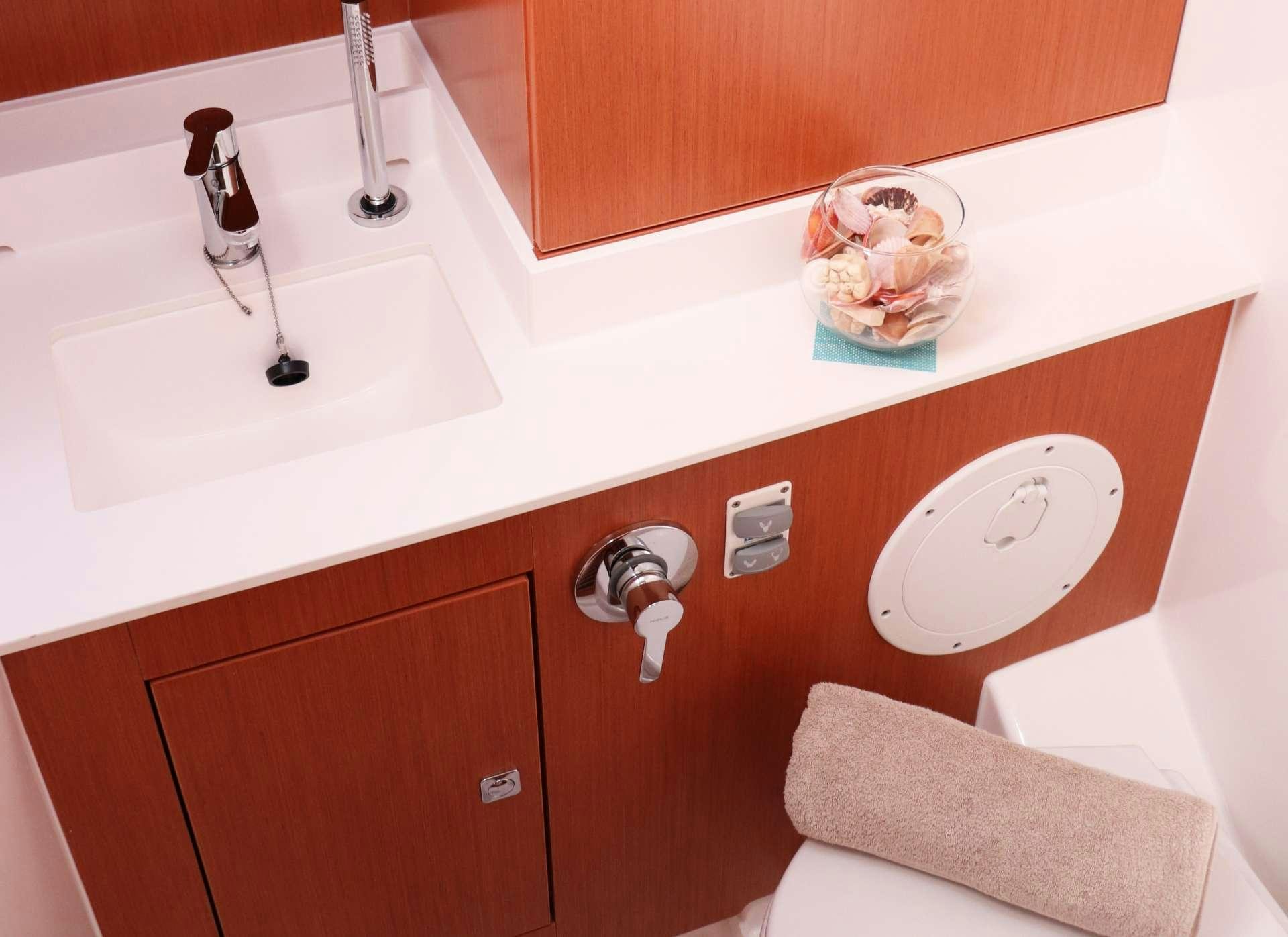 a bathroom with a sink and a toilet aboard Wyvern Yacht for Charter