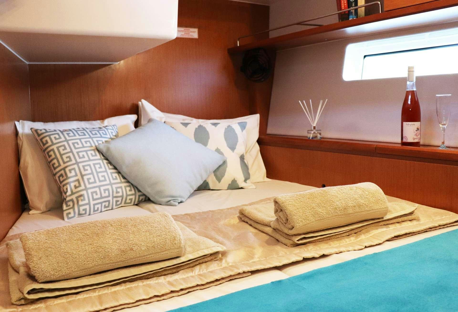 a bed with pillows aboard Wyvern Yacht for Charter