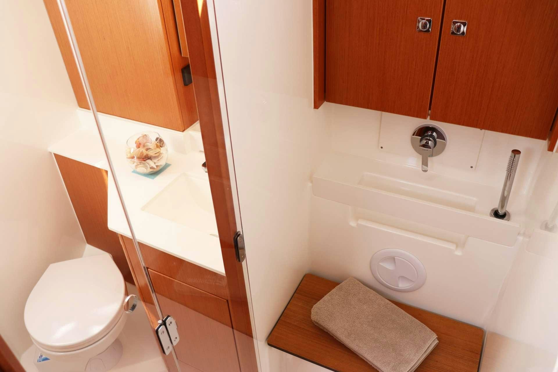 a bathroom with a toilet and a sink aboard Wyvern Yacht for Charter