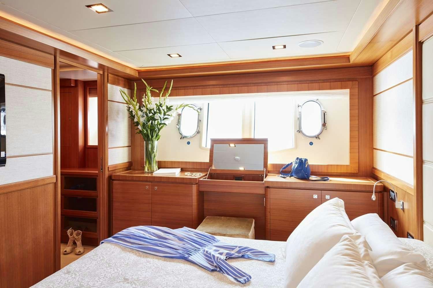 a bedroom with a desk and a bed aboard BEST OFF Yacht for Charter