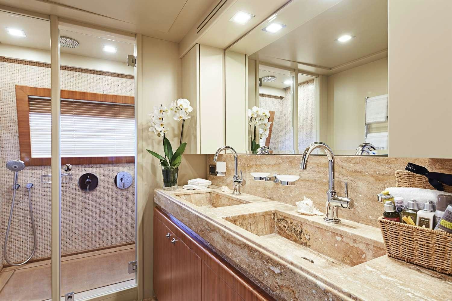 a bathroom with a sink and a shower aboard BEST OFF Yacht for Charter