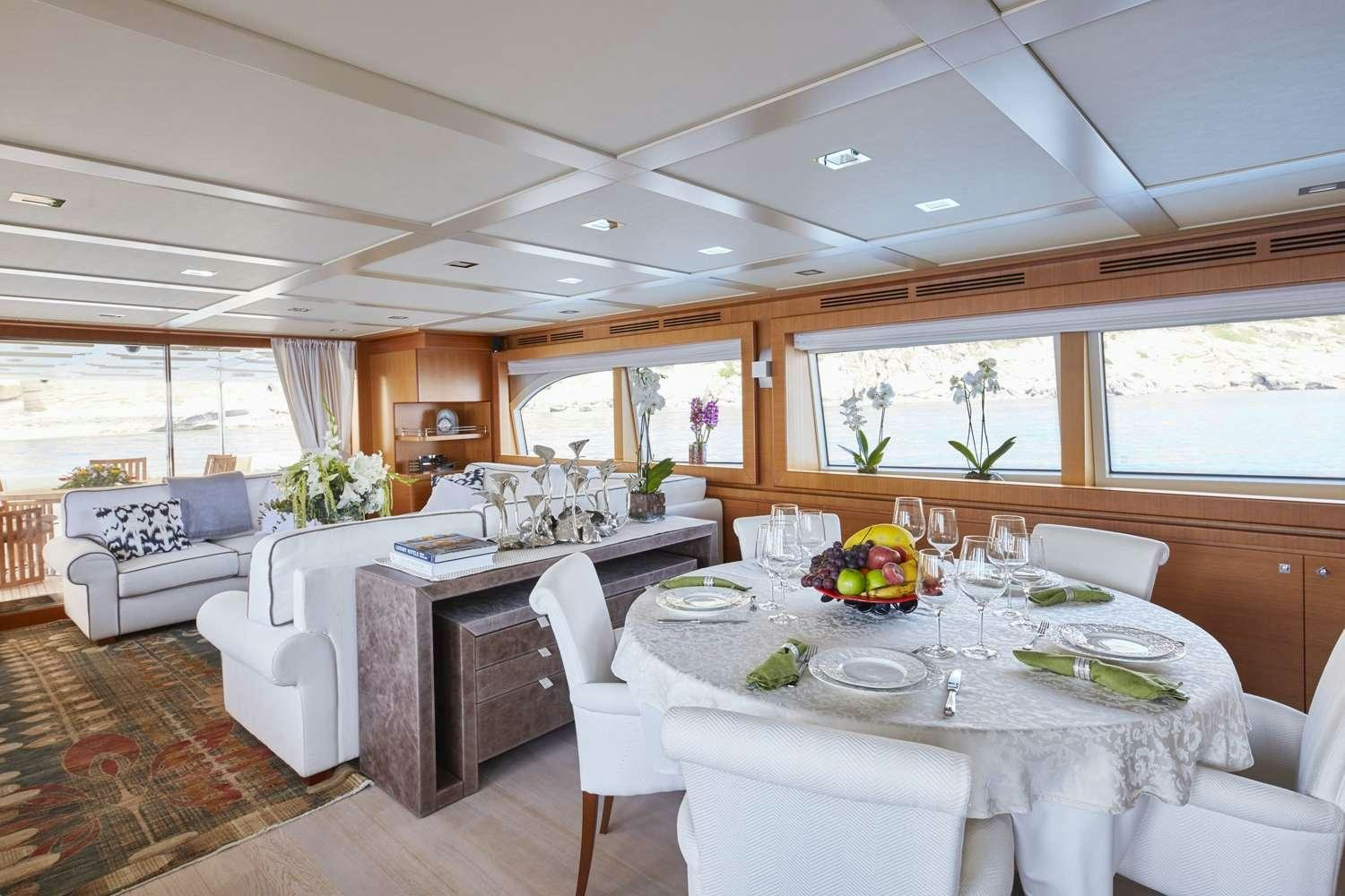 a large dining table in a living room aboard BEST OFF Yacht for Charter