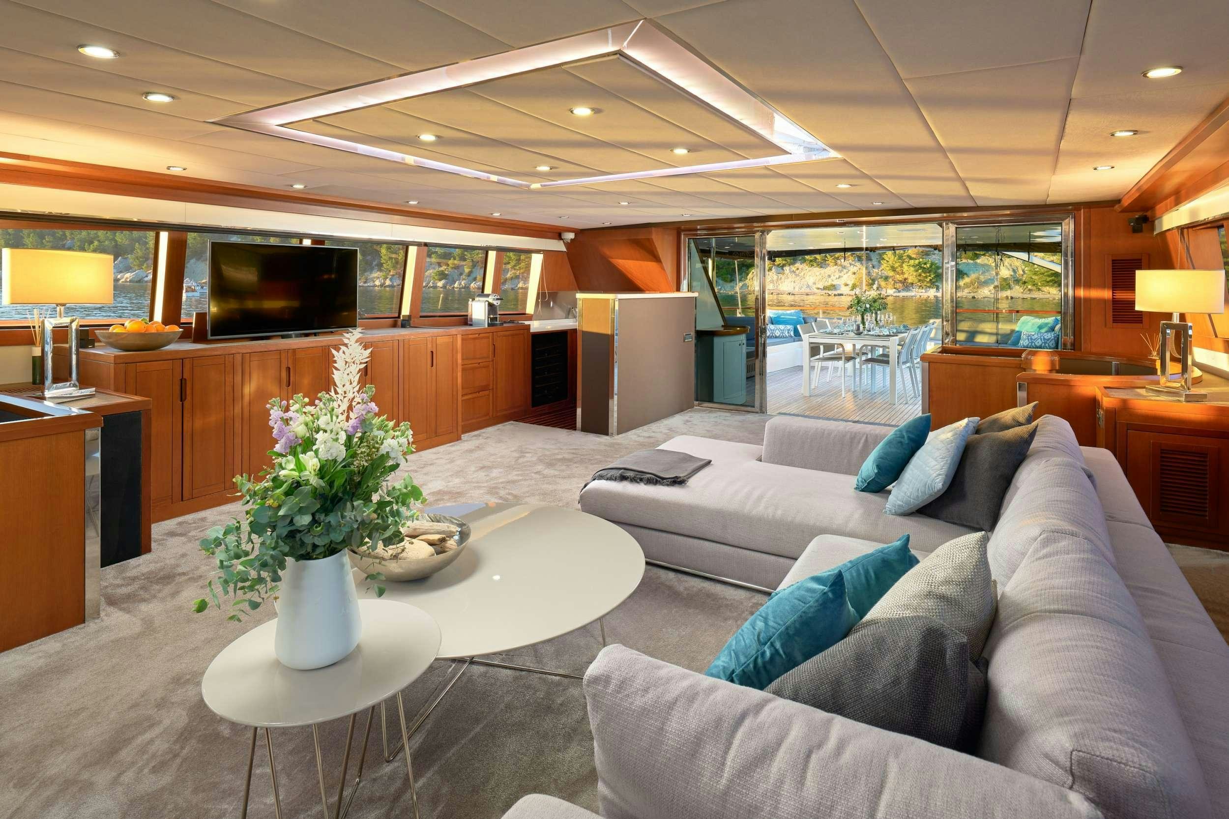 a living room with a couch and a table aboard SAN LIMI Yacht for Charter